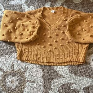 En Creme Mustard V-Neck Sweater with Textured Dots
Acrylic: 80% 
Wool:  15%